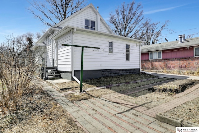 rear view of property featuring entry steps