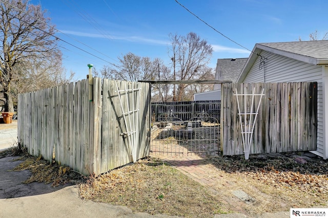 view of outdoor structure featuring a gate and fence