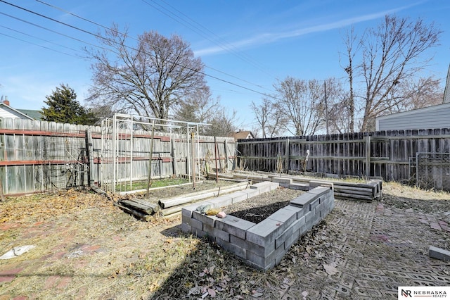 view of yard featuring a vegetable garden and a fenced backyard