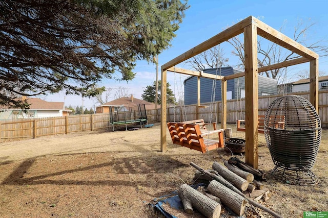 view of yard featuring a fenced backyard and a trampoline