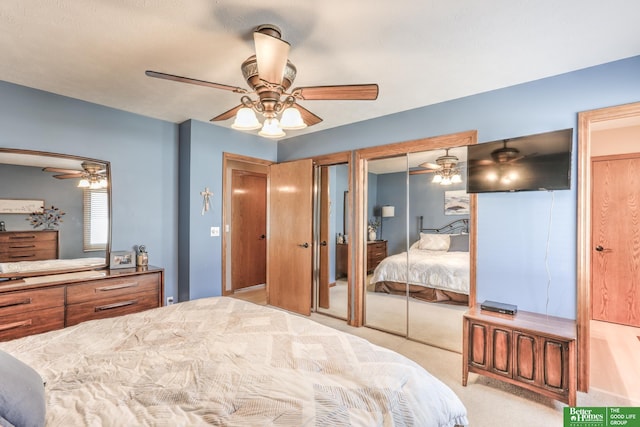 bedroom with a ceiling fan, two closets, and carpet flooring