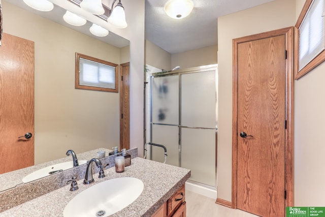 bathroom with vanity and a stall shower