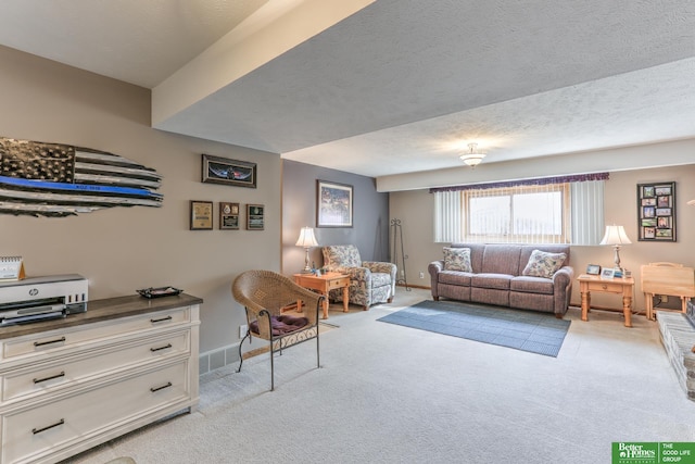 living room with visible vents, light colored carpet, baseboards, and a textured ceiling