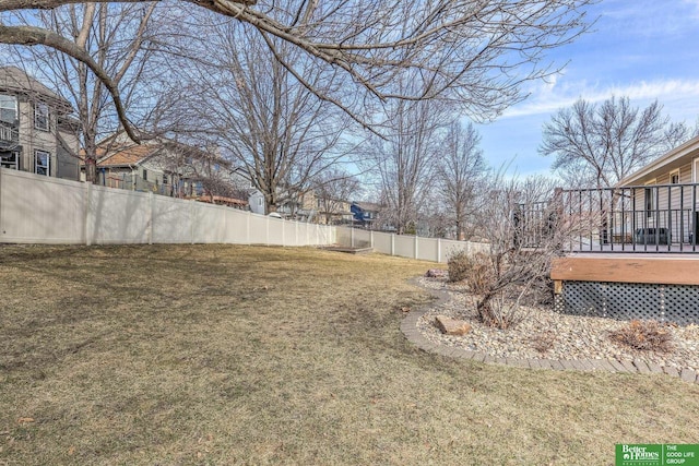 view of yard with a wooden deck and fence