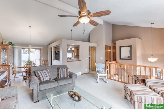 living area featuring visible vents, high vaulted ceiling, ceiling fan with notable chandelier, carpet flooring, and baseboards