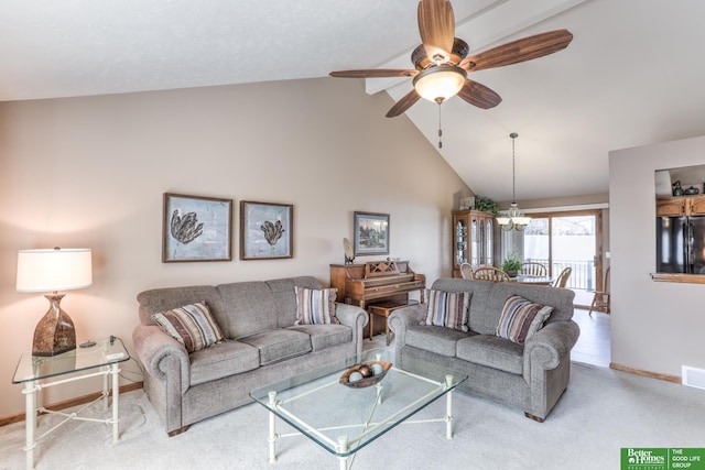 living room with carpet, visible vents, baseboards, high vaulted ceiling, and ceiling fan with notable chandelier