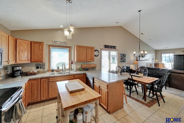 kitchen with a notable chandelier, butcher block countertops, a sink, a peninsula, and appliances with stainless steel finishes