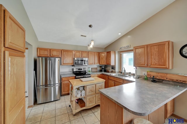 kitchen featuring a peninsula, light tile patterned flooring, a sink, stainless steel appliances, and vaulted ceiling