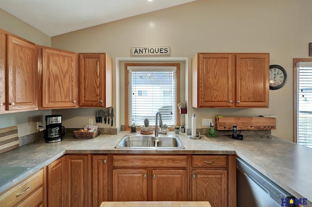 kitchen featuring a sink, stainless steel dishwasher, light countertops, and vaulted ceiling