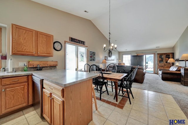 kitchen featuring an inviting chandelier, a peninsula, open floor plan, and light carpet