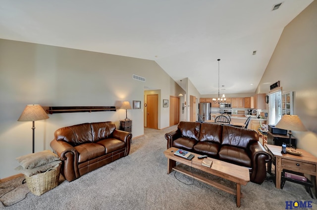 living room featuring an inviting chandelier, high vaulted ceiling, visible vents, and light carpet