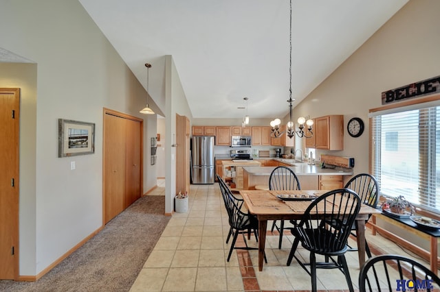 dining space featuring baseboards, high vaulted ceiling, an inviting chandelier, light tile patterned flooring, and light colored carpet