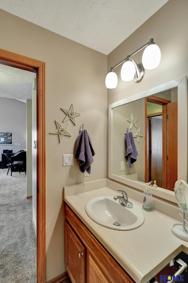 bathroom with vanity and a textured ceiling