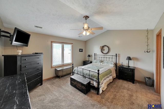 carpeted bedroom with a ceiling fan, visible vents, baseboards, lofted ceiling, and a textured ceiling