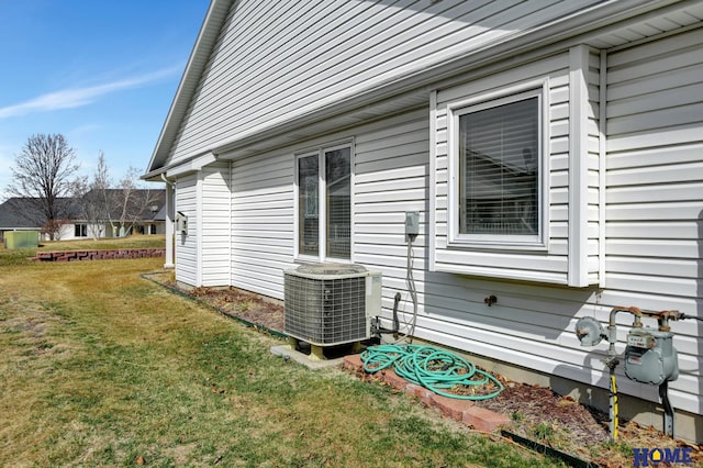 view of property exterior with a lawn and central AC unit