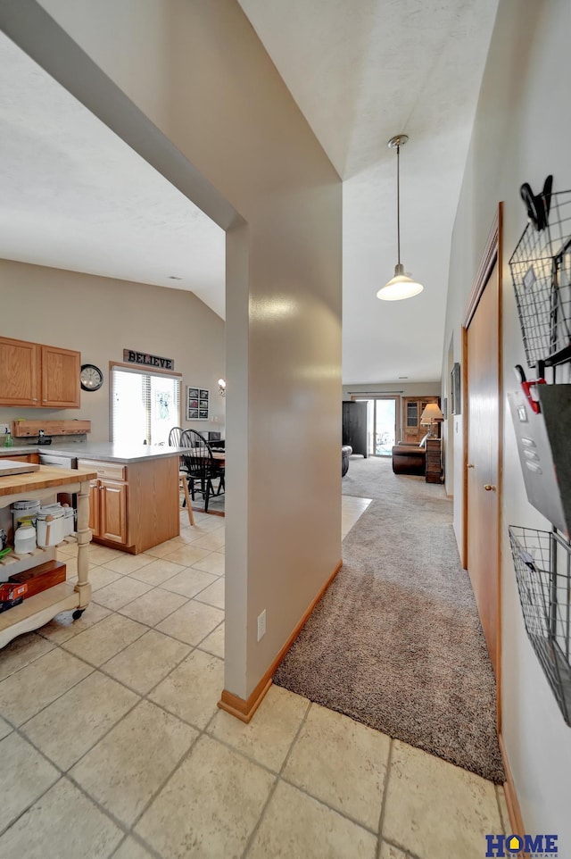 corridor with high vaulted ceiling and baseboards