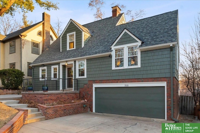 view of front of property featuring roof with shingles, a chimney, concrete driveway, a garage, and brick siding