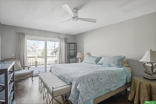 bedroom featuring a textured ceiling, access to exterior, wood finished floors, and ceiling fan