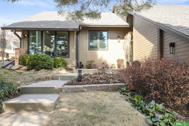 view of front of home featuring roof with shingles