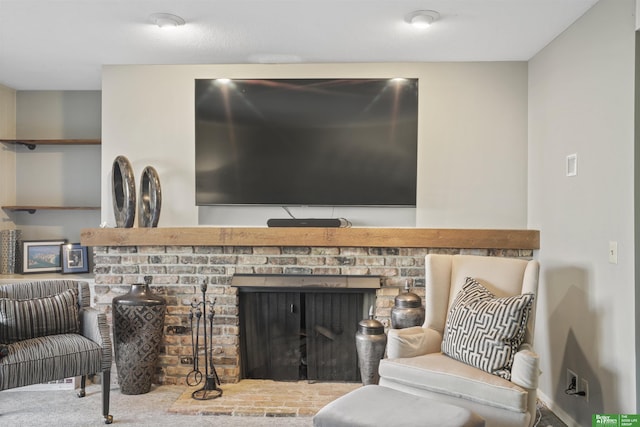 living area featuring carpet flooring and a fireplace