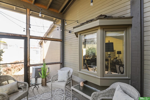 sunroom with vaulted ceiling with beams