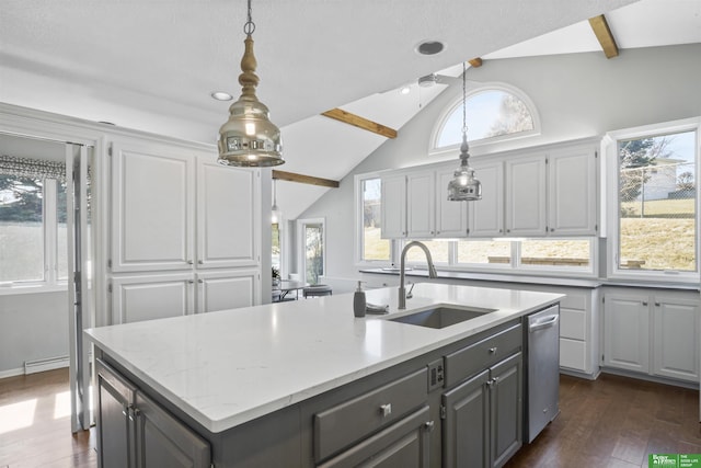 kitchen with a kitchen island with sink, vaulted ceiling with beams, stainless steel dishwasher, and a sink