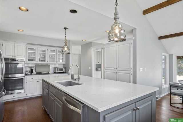 kitchen featuring gray cabinetry, a sink, white cabinetry, appliances with stainless steel finishes, and vaulted ceiling with beams