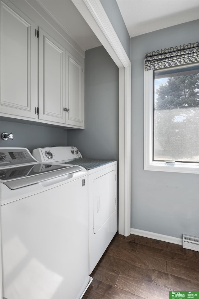 laundry room with baseboards, cabinet space, dark wood finished floors, and washing machine and clothes dryer