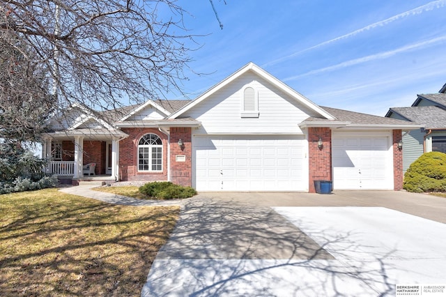 view of front of property featuring brick siding, a front lawn, concrete driveway, and a garage