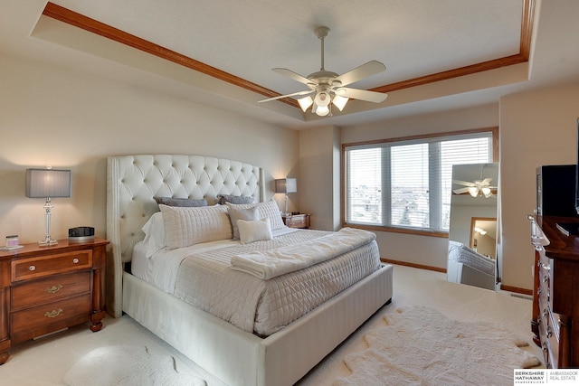 bedroom with light colored carpet, a ceiling fan, a raised ceiling, and baseboards