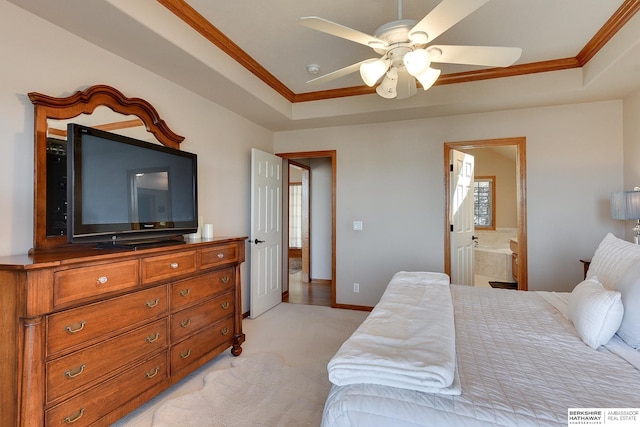 bedroom with a tray ceiling, baseboards, light colored carpet, and ornamental molding