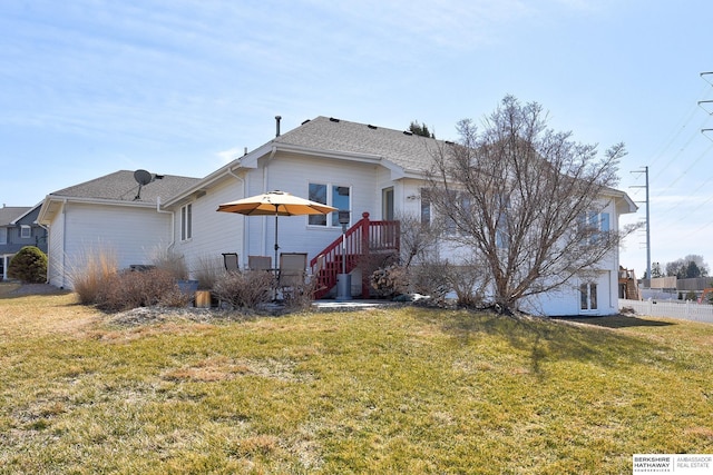 rear view of house featuring a lawn