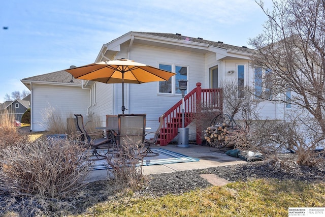 back of property featuring outdoor dining area and a patio