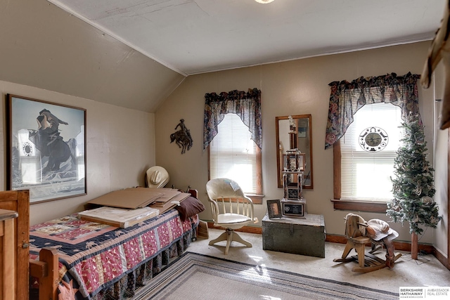 carpeted bedroom featuring baseboards and vaulted ceiling