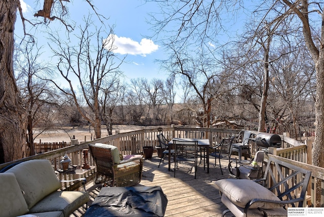 wooden terrace with outdoor lounge area, outdoor dining space, and grilling area