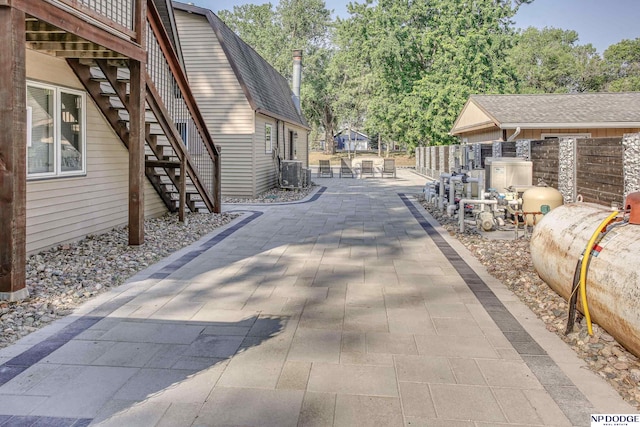 exterior space with stairway, fence, and central AC