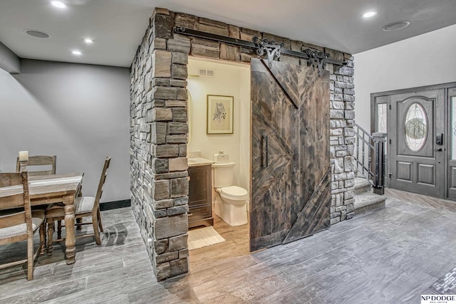 interior space with recessed lighting, toilet, wood finished floors, and visible vents