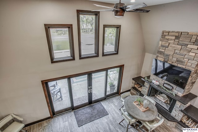 living room featuring a ceiling fan, wood finished floors, and baseboards