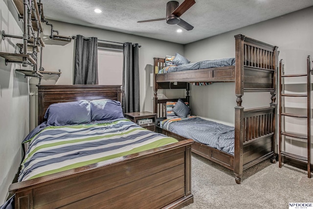 carpeted bedroom featuring recessed lighting, a textured ceiling, and a ceiling fan