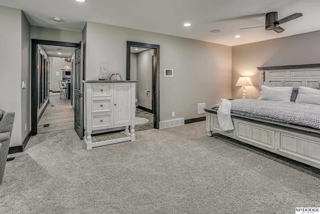 bedroom with recessed lighting, visible vents, light carpet, and baseboards