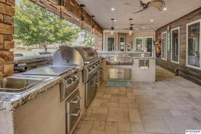 view of patio / terrace featuring an outdoor kitchen and ceiling fan