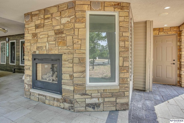 details featuring stone siding and an outdoor stone fireplace