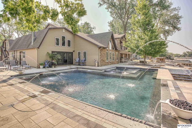 view of swimming pool featuring a patio area and a pool with connected hot tub