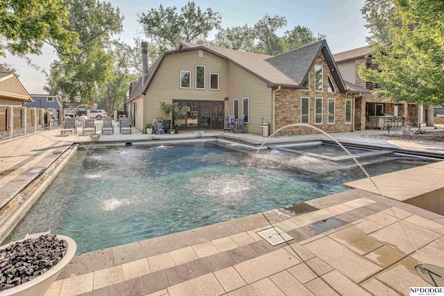 pool with a patio and fence