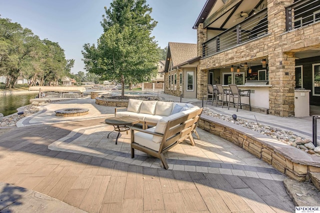 view of patio featuring an outdoor living space with a fire pit and outdoor dry bar