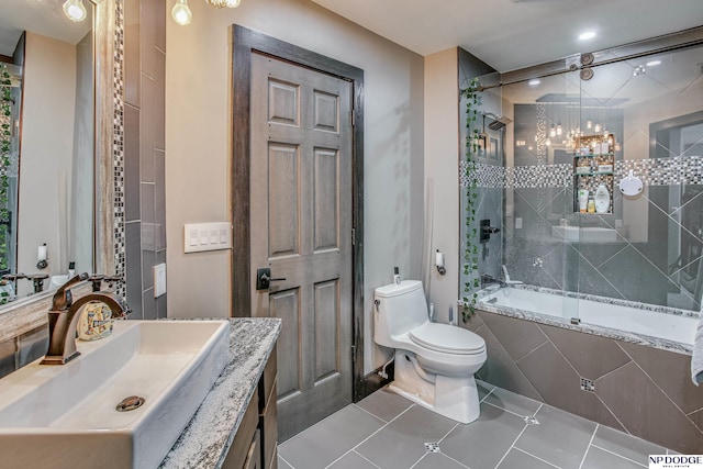 full bath featuring toilet, vanity, and tile patterned flooring