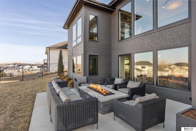 view of patio with an outdoor living space with a fire pit and fence