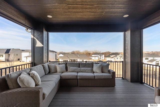 wooden deck featuring an outdoor living space and a residential view