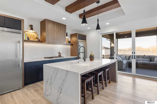 kitchen featuring decorative backsplash, appliances with stainless steel finishes, modern cabinets, and light wood-type flooring