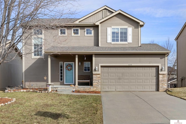 view of front facade with concrete driveway, a garage, a front yard, and stone siding